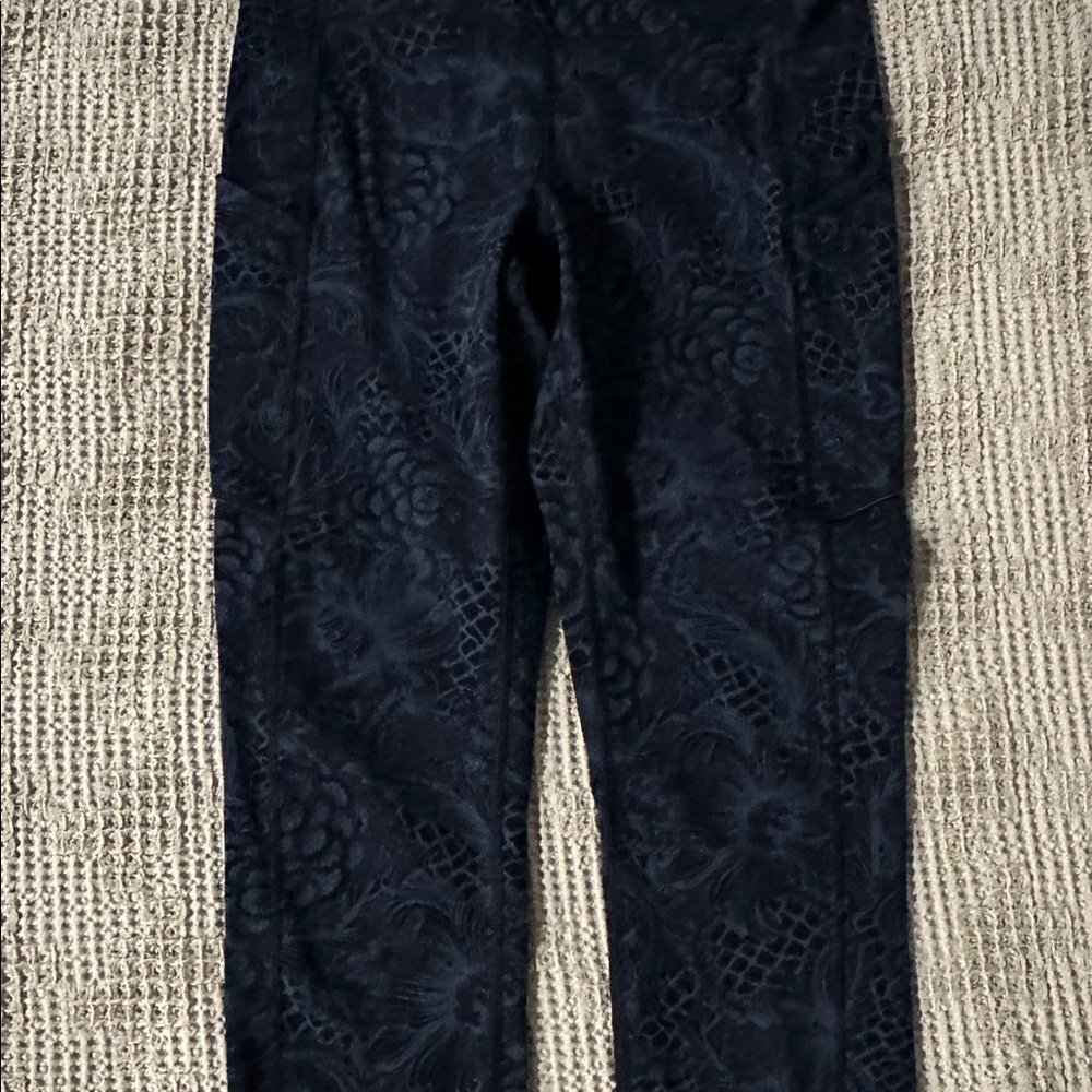 Lululemon black high-waisted leggings with floral pattern
